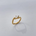 Detail of gold-plated titanium ring with marquise-cut zircon on white leather - US 6 / Long Teardrop Zircon