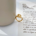 Detailed close-up of a double-layered gold ring with elegant abstract twisted wire lines - US 6 / Twisted Knot (Circle Winding)