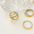 Macro shot of 18K gold and silver plated titanium steel wave rings on a white surface - Fixed Curved Double Ring Style