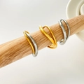 Close-up of dual-layer wavy beaded rings in gold and silver finish on wooden stand - US 6 / Streamlined Curved Double Ring Style / Gold