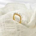 Detail of seven white freshwater pearls on a gold titanium steel adjustable ring band - US 6 / Wave Row Pearls