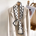 Elegant white polka dot skinny silk scarf styled on a beige blazer for a chic work look - Off White