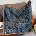 Detail of silk square scarf hanging on a leather sofa with navy geometric L-patterning - 90*90cm / Navy Blue (XW-26)