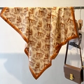 Detailed close-up of a geometric print twill square scarf with caramel orange border - 90*90cm / Brown