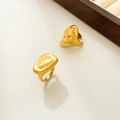Macro detail of 18K gold plated irregular lava ring on minimalist beige background - Large Concave Style