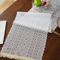 White hollow-out knit table runner with boho tassels on a dark wood table - 35x91cm / Triangle Stripe 1