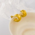 Close-up of chunky gold C-shaped hoop earrings with polished mirror finish on white ceramic - Wide Wave Edge C
