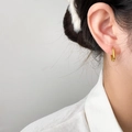 Minimalist geometric gold hoop earrings with polished finish shown on model - Gold Hollow Oval Style