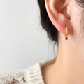 Close-up of 18K gold plated hoop earring featuring a mini ruby-red zircon pendant and pearl - Mini Red Zirconia