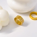 Macro shot of gold-plated titanium steel rings featuring detailed geometric honeycomb patterns - US 6 / Polygonal Hollow Carved