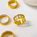 Detail of 18K gold-plated titanium steel rings featuring hollow poker suits and textures - Poker Symbols