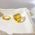 Detail of 18K gold-plated multilayer geometric rings on a minimalist stone tray - US 6 / 4 Layer Hollow Open