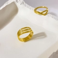 Macro detail of multi-layer 18K gold plated geometric ring on a white textured stone - US 6 / Three Layer Hollow Curved Closed