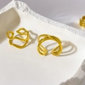 Detail of 18K gold plated multi-layer crisscross and wavy geometric rings on stone tray - US 6 / Three Lines Cross Open