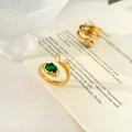 Macro detail of gold-plated wrap rings with emerald-green gems and clear zircon crystals - US 6 / Double Snake Head Green White Zircon