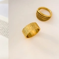 Detailed view of wide textured gold band and layered multi-line stackable ring - US 6 / Lava Hammered Texture Style / Gold