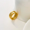 Close-up of golden multi-layer crisscross ring with matte and polished steel textures - US 6 / Multi-Layer Intertwined Wrap Style / Gold