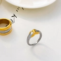 Macro detail of two-tone gold and silver knot ring with polished stainless steel finish - X-Symbol Knot Style
