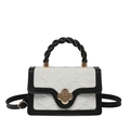 Chic monochrome crossbody bag with white embossed texture and gold floral clasp lock - Black and White