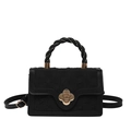 Black vintage crossbody bag with gold floral clasp and woven handle on white background - Black