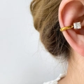 Macro view of gold ear cuff with square-cut cubic zirconia worn on a model's ear - Large Square Zirconia Style