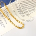 Detail of gold and silver paperclip link necklaces displayed on a minimalist book background - Hollow Paperclip Chain Style / Electroplated Silver
