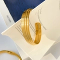 Polished gold cuff bracelet with vertical stripes on artistic card display - Gold Multi-line Open Cuff (6.6cm Diameter 1.3cm Width)
