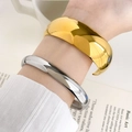 Polished gold wide cuff and silver slim bangle set on wrist for minimalist fashion - Curved Mirror Bangle 2cm Width Gold