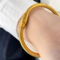 Detail of gold snake chain bracelet featuring a polished texture and secure mechanical clasp - Gold Snake Bone Textured Buckle Bracelet