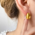 Close-up of polished gold teardrop stud earring showing glossy finish and size on ear - Teardrop Large / Gold