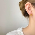 Minimalist gold teardrop stud earrings in stainless steel on female model ear - Teardrop Small / Gold