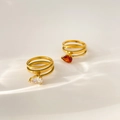 Macro detail of teardrop zircon rings with triple-layer wave bands in gold finish - US 6 / Spiral Red Teardrop