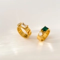Detailed macro view of gold-plated rings with emerald green and clear zircon stones - US 6 / White Rectangular + Round Zirconia