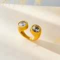 Macro detail of gold-plated snake-style ring featuring dual zircon stones and ribbed texture - Round Zircon Open