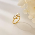 Detailed shot of golden pear-cut zircon and white pearl on a curved double-layer ring - US 6 / Waterdrop Zirconia + Pearl