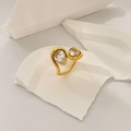 Detail of 18K gold plated steel ring featuring two sparkling pear-cut cubic zirconia stones - Large and Small Waterdrop Zirconia