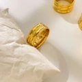 Detailed close-up of 18K gold-plated textured ring with triple arc groove patterns - US 6 / Concave Rhombus