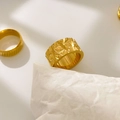 Macro detail of 18K gold plated titanium rings with geometric diamond texture and vertical grooves - US 6 / Irregular Cut