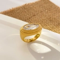 Macro view of large oval-cut clear zircon stone on a wide 18K gold-plated band - Large Oval Zirconia