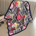 Close-up of houndstooth silk scarf with autumn leaf patterns draped on a leather sofa - 70*70cm / Navy Blue Pink