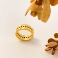 Detailed view of 18K gold plated wide band ring featuring hollow circular patterns - US 6 / Circular Hole Style