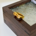 Gold plated ring with BRO letter design and oval zircon on dark wooden jewelry box - US 6 / BRO Letter Style