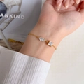 Détail d'un bracelet doré avec oxydes de zirconium tailles marquise et princesse - Bracelet en Zircone Losange Carré