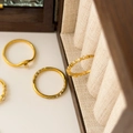 Close-up of minimalist 18K gold plated stackable rings with delicate micro diamonds - US 6 / Round and Rhombus Zirconia