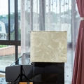 Golden jacquard piano cover with leaf pattern on a black piano in a home setting - Gold Leaves (Beige Gold Jacquard Leaf Style)
