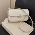 Chic cream-colored glossy underarm bag with silver buckle and floral charm detail - Beige Grey