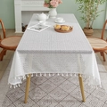 White geometric crochet lace tablecloth with fringe tassels on a wooden dining table - 140*100cm / White