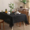 Elegant black hollow lace tablecloth with fringe tassels on a wooden dining table - 140*100 / Black