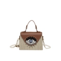 Stroh-Handtasche mit brauner Lederklappe, einzigartigem Augen-Design und Kordelriemen - Braun