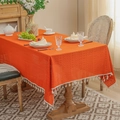 Rectangle orange hollow lace tablecloth with white tassels on a rustic wooden dining table - 140*100 / Orange